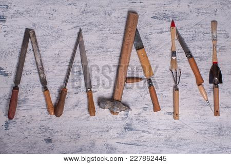 The Inscription Man Is Written By Work Tools. The Word Man Is Made Up Of A Work Tools.