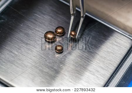 The Work Of Jewelers. The Jeweler Weighs The Copper Granules On A Digital Scale. Selective Focus. Ma