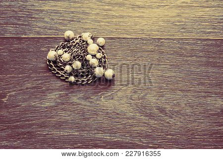 Wooden Dark Vintage Background. Metal Gold Chain With Pearls. Top View Flat Lay