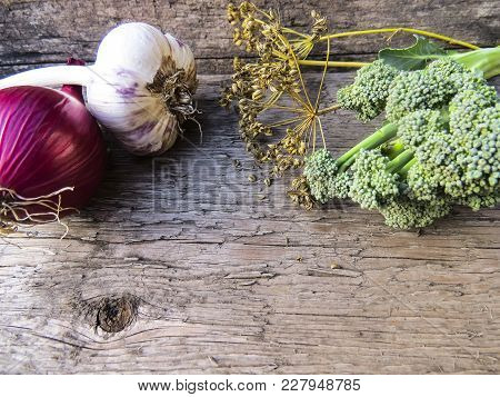 Vegetables  From Organic Grower Farm On A Wooden Background.garlic, Onion And Broccoli.top View. Pla