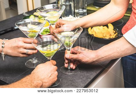 Hands Of Friends Having Fun At House Party With Pre Dinner Aperitif Martini Cocktails And Chips Oliv
