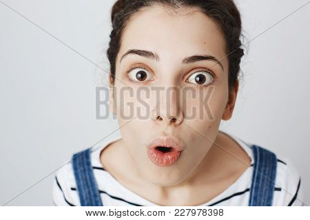 Impressed And Surprised Woman With Pierced Nose, Looking Up At Camera With Widened Eyes And Opened M