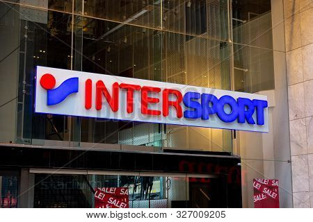 Stockholm, Sweden - April 28, 2019: The Logo Of Intersport Clothing Retail Shop Above An Entrance Wi