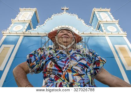 Caruaru, Pernambuco, Brazil - July 11, 2016: Woman With Traditional Clothing In Front Of A Blue Chur