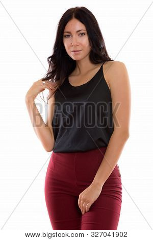 Studio Shot Of Young Beautiful Businesswoman Standing While Touc