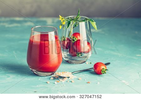 Glasses Of Fresh Delicious Jummy Red Tomato Juice And Fresh Raw Tomatoes With Pink Salt In Spoon On