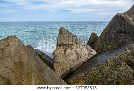 Seascape. Concrete Blocks On A Background Of Stormy Marine Background. Bolata Beach, Northern Black 