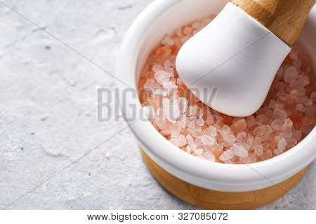 Pounder With Pink Sea Salt On Light Background Copy Space.