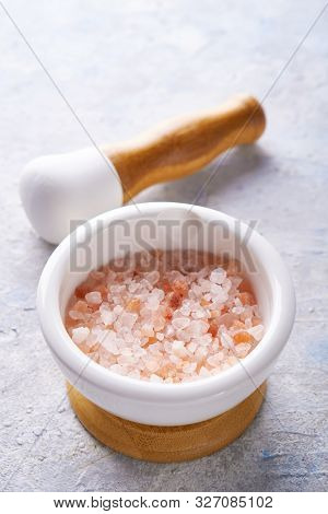Pounder With Pink Sea Salt On Light Background Copy Space.