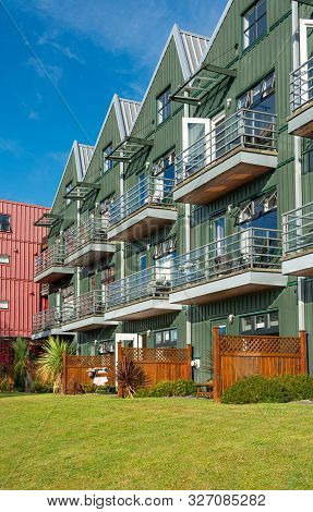 Residential Apartment Building With Green Lawn In Front