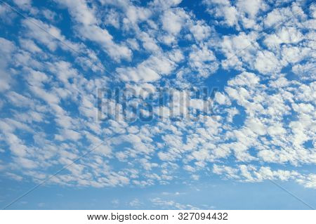 Beautiful Fluffy White Clouds In Blue Sky . Altocumulus Cloud Formation
