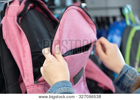 Student Girl Choosing A New Backpack In A Store.