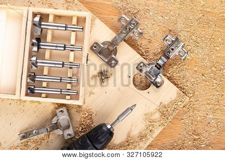 Installation Of Furniture Hinges In Chipboard. Small Carpentry Work In The Workshop.