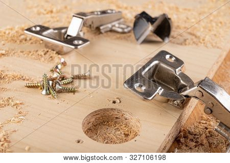 Installation Of Furniture Hinges In Chipboard. Small Carpentry Work In The Workshop.