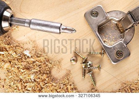 Installation Of Furniture Hinges In Chipboard. Small Carpentry Work In The Workshop.
