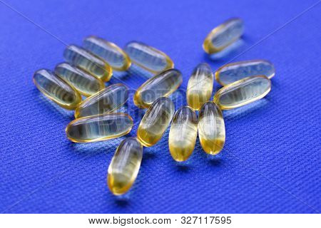 Omega 3 Capsules On A Blue Background. Proper Nutrition, Nutritional Supplements, The Concept Of Hea