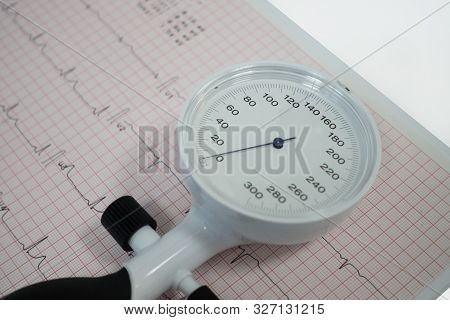 Sphygmomanometer With Aneroid Gauge With Electrocardiogram Paper. Sphygmomanometer With Aneroid Gaug