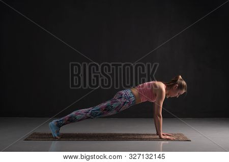 Woman Practicing Yoga, Doing Push Ups Exercise, Phalankasana, Plank Pose.