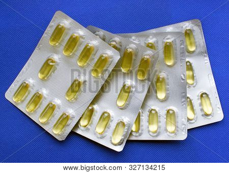 Omega 3 Capsules  In Blisters On A Blue Background. Proper Nutrition, Nutritional Supplements, The C