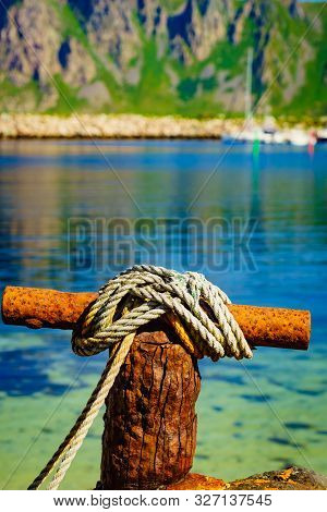 Harbor Marina Detail. Old Rusty Mooring Bollard With Rope. Bleik Village, Andoya Island, Vesteralen 