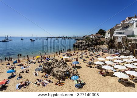 Cascais - August 14, 2019: View Of The Crowded Pretty Little Beach Named Praia Da Rainha Along The B