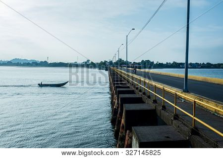 Man On Speed Boat Crossing A Bridge In The Port Of Tumaco, Colombia