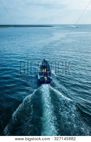 Tumaco, Nariño / Colombia, June 27, 2019: Man On Blue Empty Speed Boat