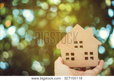 Copyspace Model Of A Little House That Woman Holds It Background.
