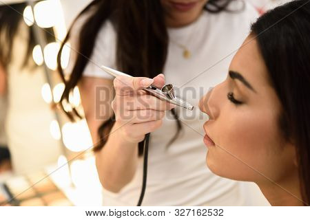 Make-up Artist Using Aerograph Making An Airbrush Make Up
