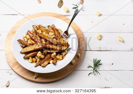 Fast Food Poutine With Fork Dug In.