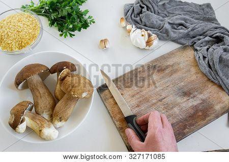 Personal Perspective Of Woman Hands Preparing Porcini Mushrooms (boletus Edible) For Cooking Them