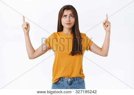 Skeptical, Unsure Good-looking Brunette Woman Smirk With Dismay Or Scorn, Frowning Suspicious, Point