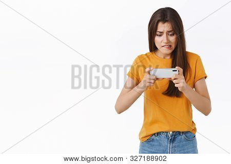Perplexed Attractive Young Female Student Forget About Duties As Playing Intense Awesome New Mobile 
