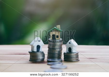 The House Placed On A Coin Is Like A Village Or Condo. Planning Savings Money Of Coins To Buy A Home