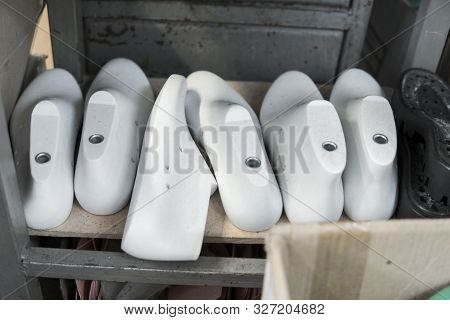Plastic Lasts Used In The Manufacture Of Shoes. Row Of Plastic Shoe Lasts Used To Manufacture Modern
