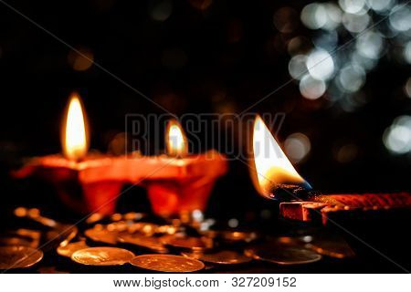 Deepawali Concept. Low Light Photo Of Two Blurred Earthen Lamps With One Lamp In The Foreground And 