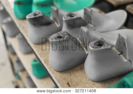 Plastic Lasts Used In The Manufacture Of Shoes. Row Of Plastic Shoe Lasts Used To Manufacture Modern