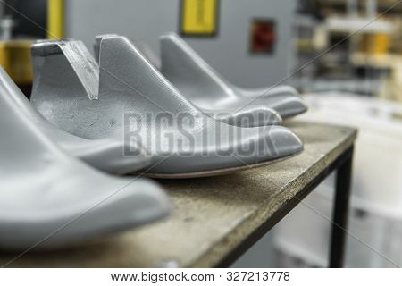 Plastic Lasts Used In The Manufacture Of Shoes. Row Of Plastic Shoe Lasts Used To Manufacture Modern