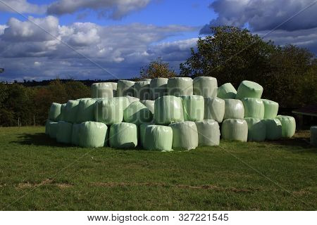 Hay Bales That Are Packed With Foil Store In A Meadow