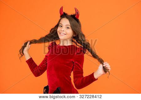 Beautiful Small Imp. Girl Red Horns Celebrate Halloween. Carnival Concept. Small Child With Imp Styl