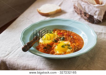 Shakshuka With Bread On A Wooden Table. Middle Eastern Traditional Dish. Homemade. Selective Focus.