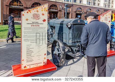 Moscow, Russia - October 08, 2019: Elderly Man Near Restored Soviet Arable Wheel Tractor Stz On The 