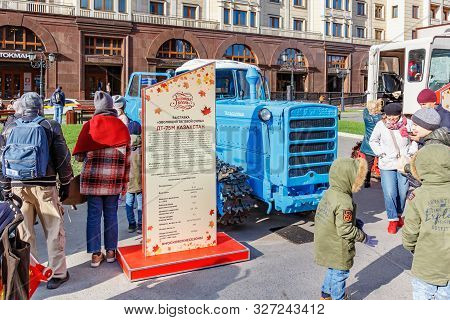 Moscow, Russia - October 08, 2019: People Against Restored Soviet Arable Crawler Tractor Dt-75m Kaza