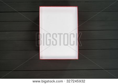 Empty Open White Cardboard Box On Black Wooden Background. Top View