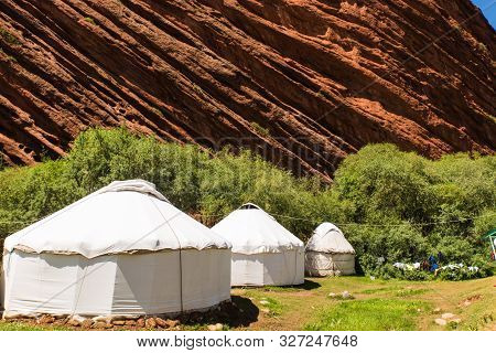 Three White Yurt Houses At Seven Bulls Jeti Ogyz Valley Red Sandstone Formation In Kyrgyzstan