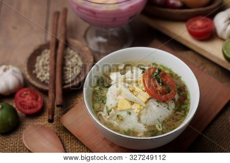 Food Photography, Bubur Ayam Or Indonesian Chicken Porridge Served With Chicken Broth Soup And Tomat