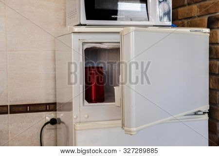 Brest, Belarus - August, 2, 2019: image of a refrigerator and a microwave oven in a hotel kitchen in Brest