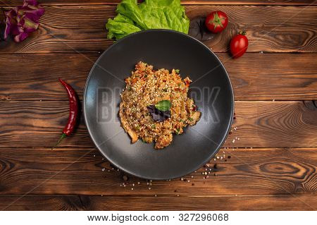 Tori Tyahan Fried Japanese Rice With Vegetables And Chicken In Soy Sauce In A Black Plate On A Woode