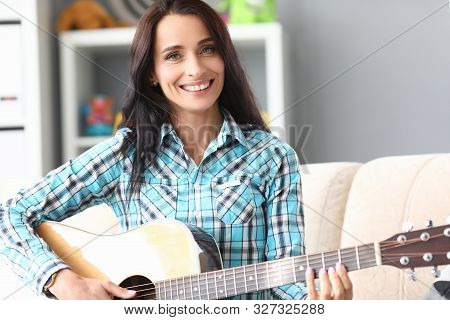 Portrait Of Wonderful Woman Enjoying Playing Classical Guitar. Beautiful Girl Looking At Camera With