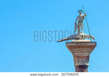 Statue Of St Theodore With A Crocodile On An Ancient Pillar On The Piazza San Marco, Venice, Italy. 